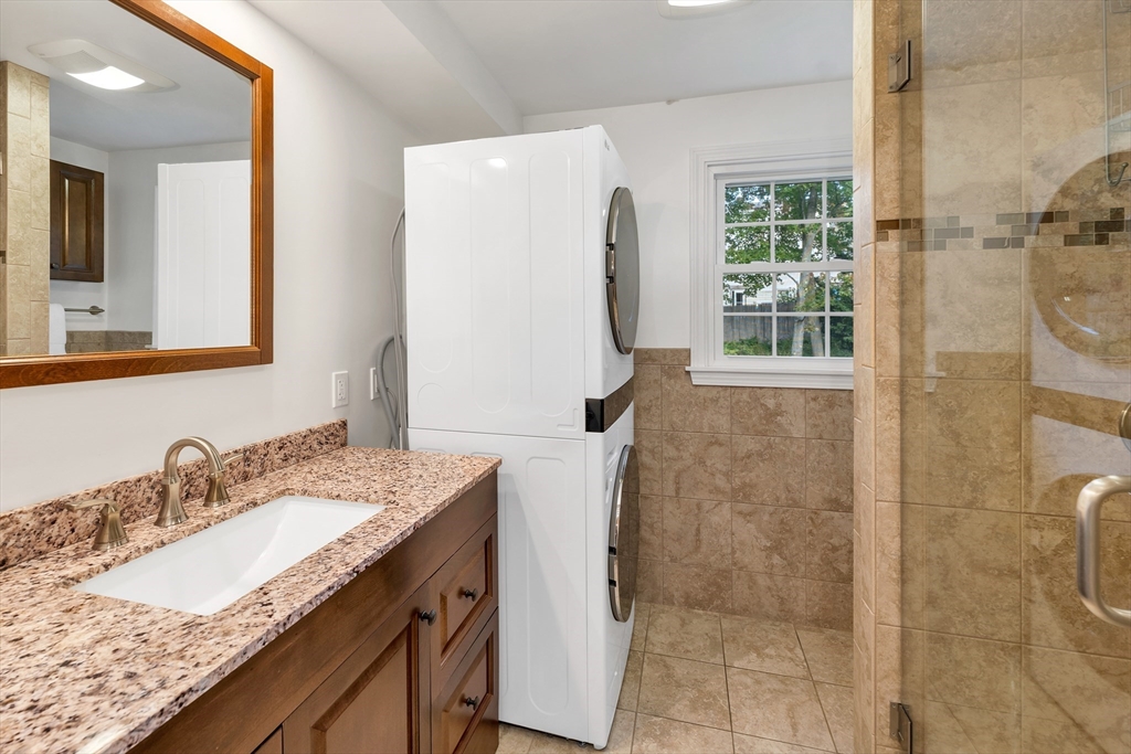 81 Magnolia Road Manchester, NH 03104 - Photo 12 of 35 a bathroom with a granite countertop sink and a mirror