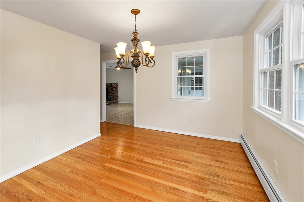 81 Magnolia Road Manchester, NH 03104 - Photo 17 of 35 a view of a livingroom with wooden floor and chandelier