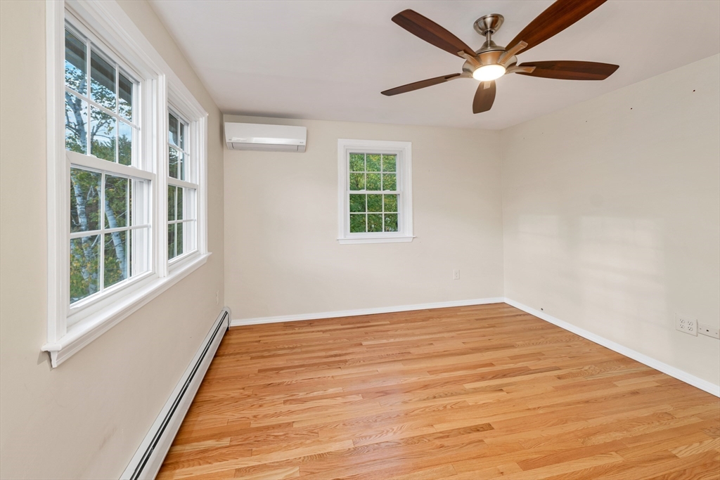 81 Magnolia Road Manchester, NH 03104 - Photo 28 of 35 a view of an empty room with wooden floor and a window