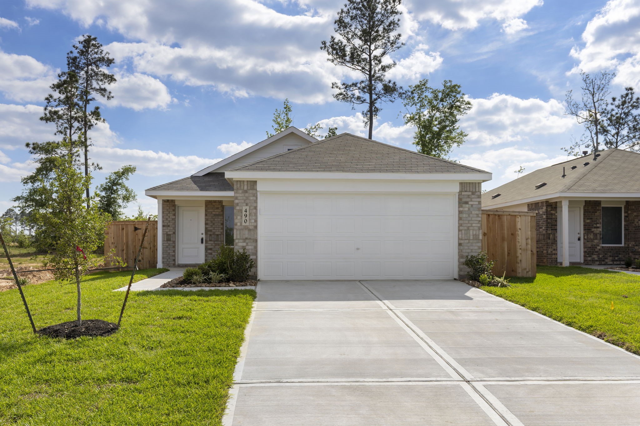 490 Southern Magnolia Way Magnolia, TX 77354 - Photo 24 of 25 a front view of a house with a yard and garage