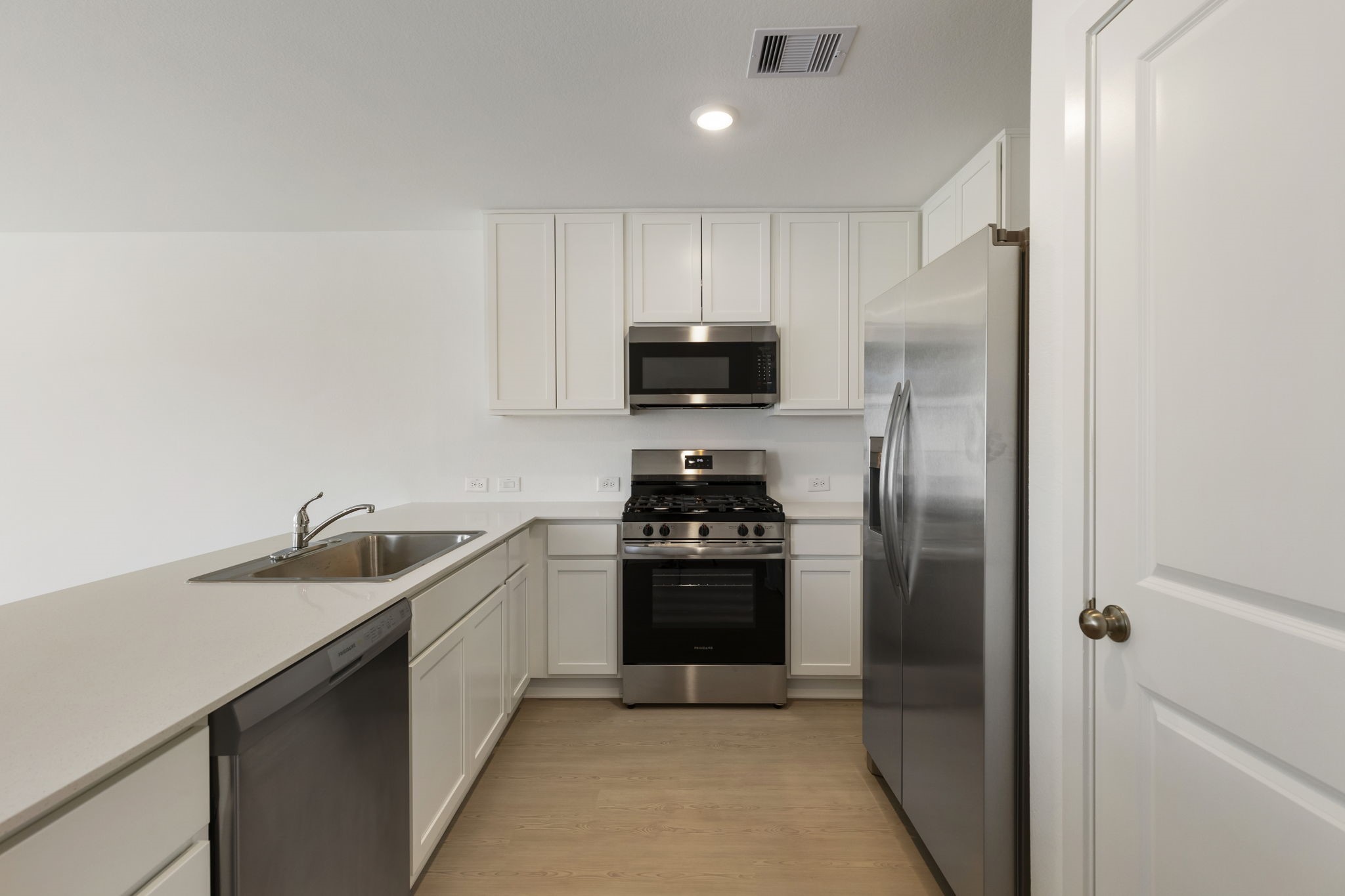 490 Southern Magnolia Way Magnolia, TX 77354 - Photo 8 of 25 a kitchen with granite countertop a refrigerator and a sink