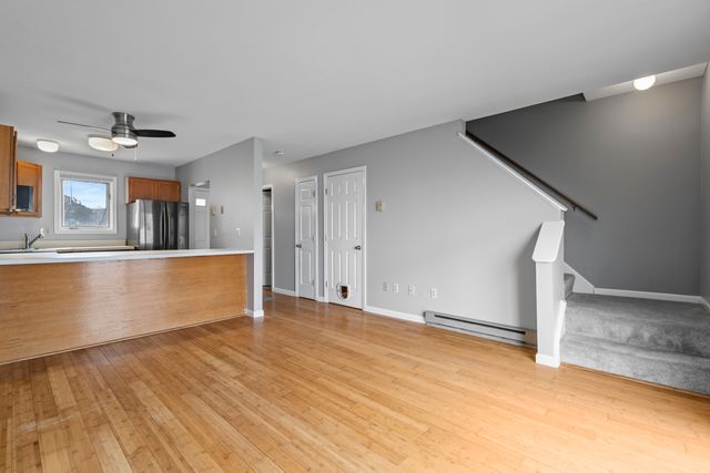 a view of a kitchen with kitchen island a sink wooden floor and a counter top space