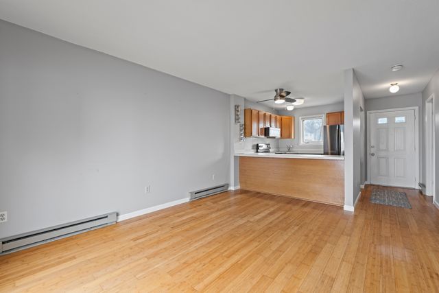 a view of a kitchen with wooden floor and a kitchen