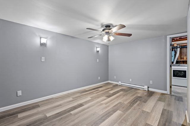 a view of an empty room with closet and a window