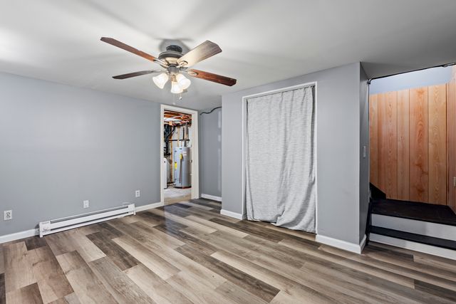 a view of a livingroom with a ceiling fan and window