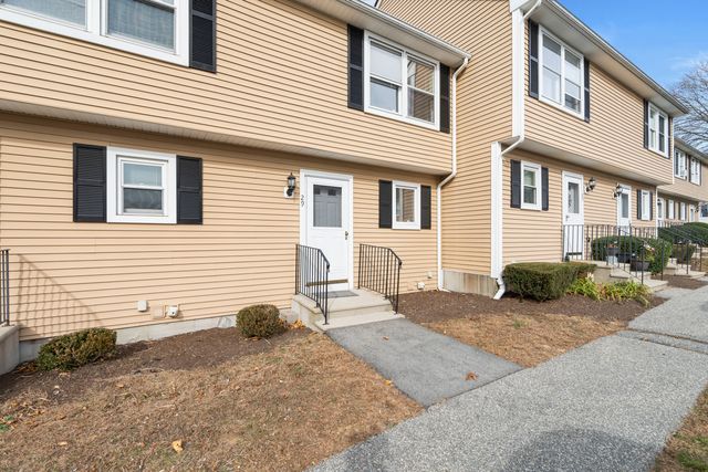 a view of a house with backyard and chairs