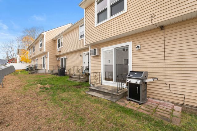 a view of a house with backyard and a chair