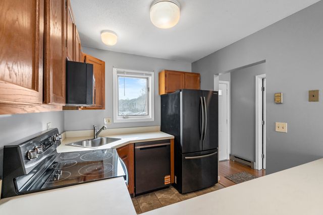 a kitchen with stainless steel appliances granite countertop a refrigerator and a sink