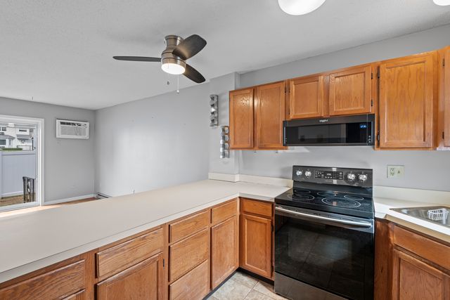 a kitchen with stainless steel appliances a stove microwave and sink