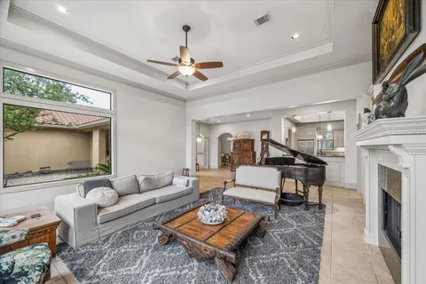 a living room with furniture a fireplace and a flat screen tv