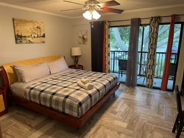 a bedroom with a large bed and a chandelier