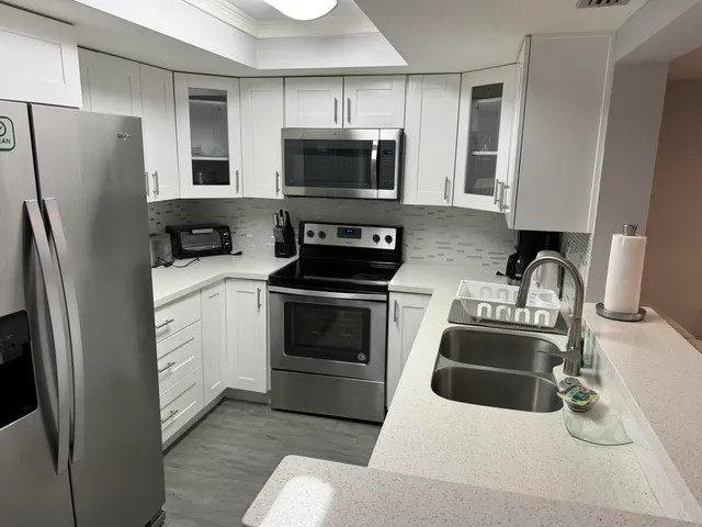 a kitchen with stainless steel appliances a stove a microwave and a refrigerator