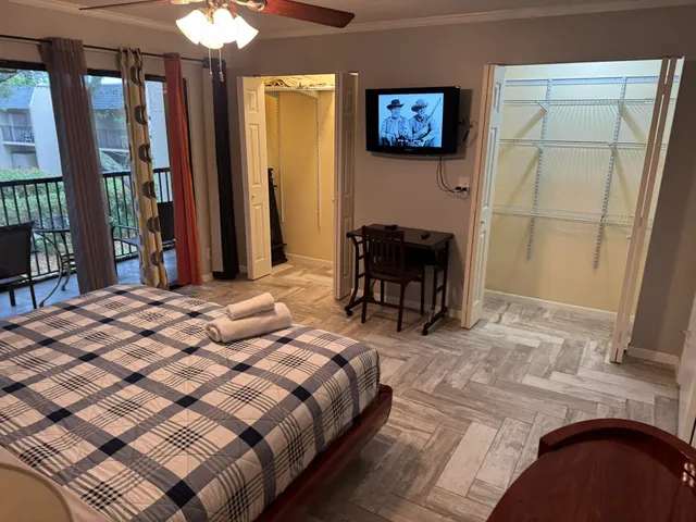 a bedroom with a bed and a television