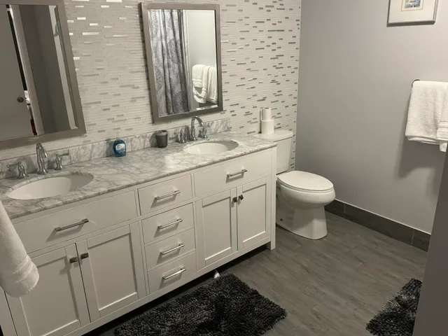 a bathroom with a toilet sink and mirror