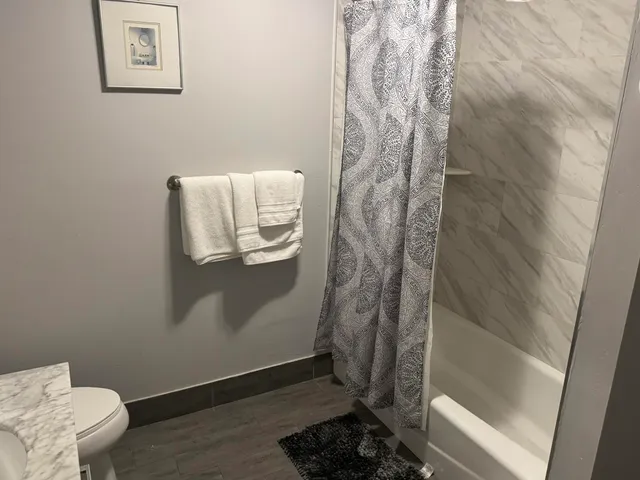 a bathroom with a toilet and shower