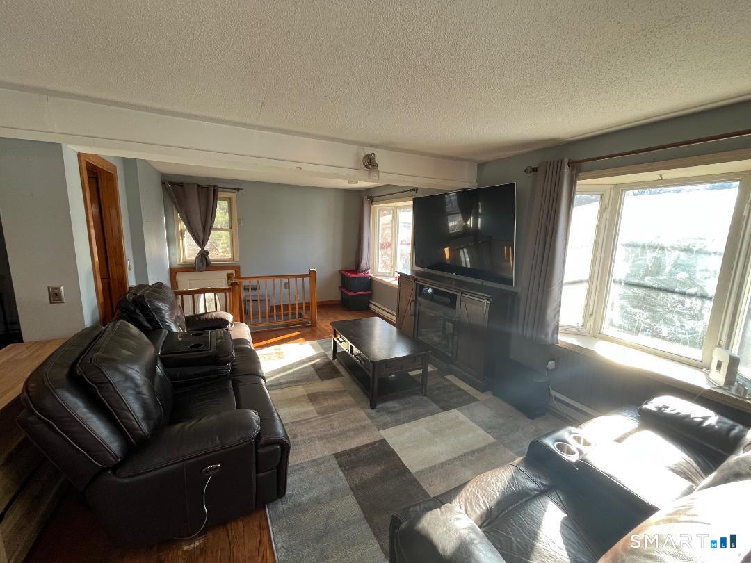 61 Tankerhoosen Road Vernon, CT 06066 - Photo 11 of 34 a living room with furniture and a large window