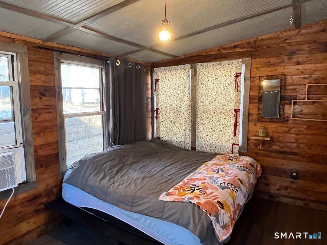 61 Tankerhoosen Road Vernon, CT 06066 - Photo 16 of 34 a bedroom with a large bed and a window