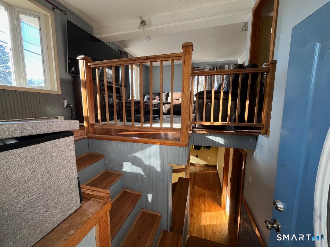 61 Tankerhoosen Road Vernon, CT 06066 - Photo 20 of 34 a view of staircase with lots of wooden furniture and a window