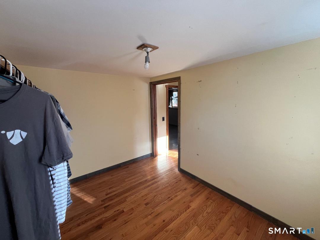 61 Tankerhoosen Road Vernon, CT 06066 - Photo 26 of 34 a view of an empty room with wooden floor and a window