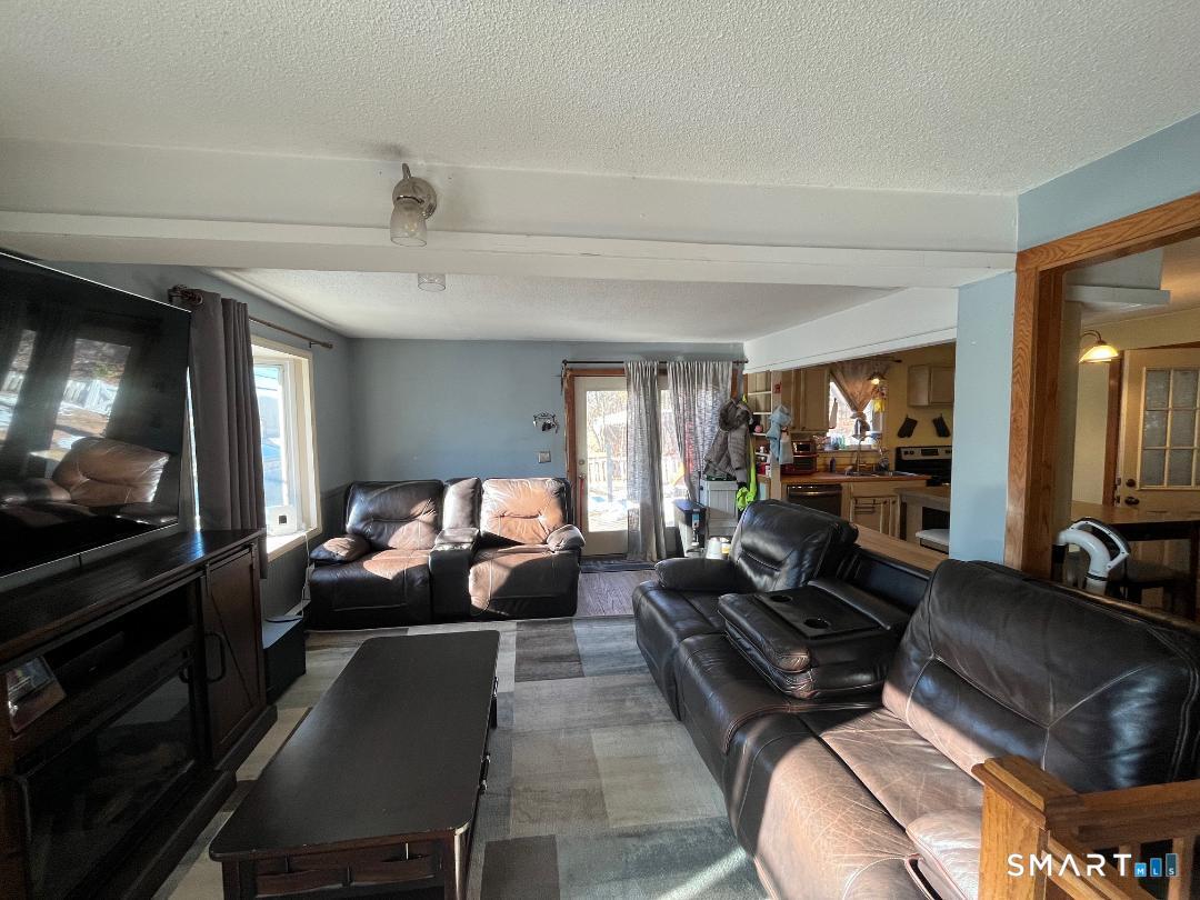 61 Tankerhoosen Road Vernon, CT 06066 - Photo 8 of 34 a living room with furniture and a flat screen tv