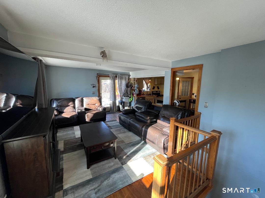 61 Tankerhoosen Road Vernon, CT 06066 - Photo 10 of 34 a living room with furniture and a wooden floor