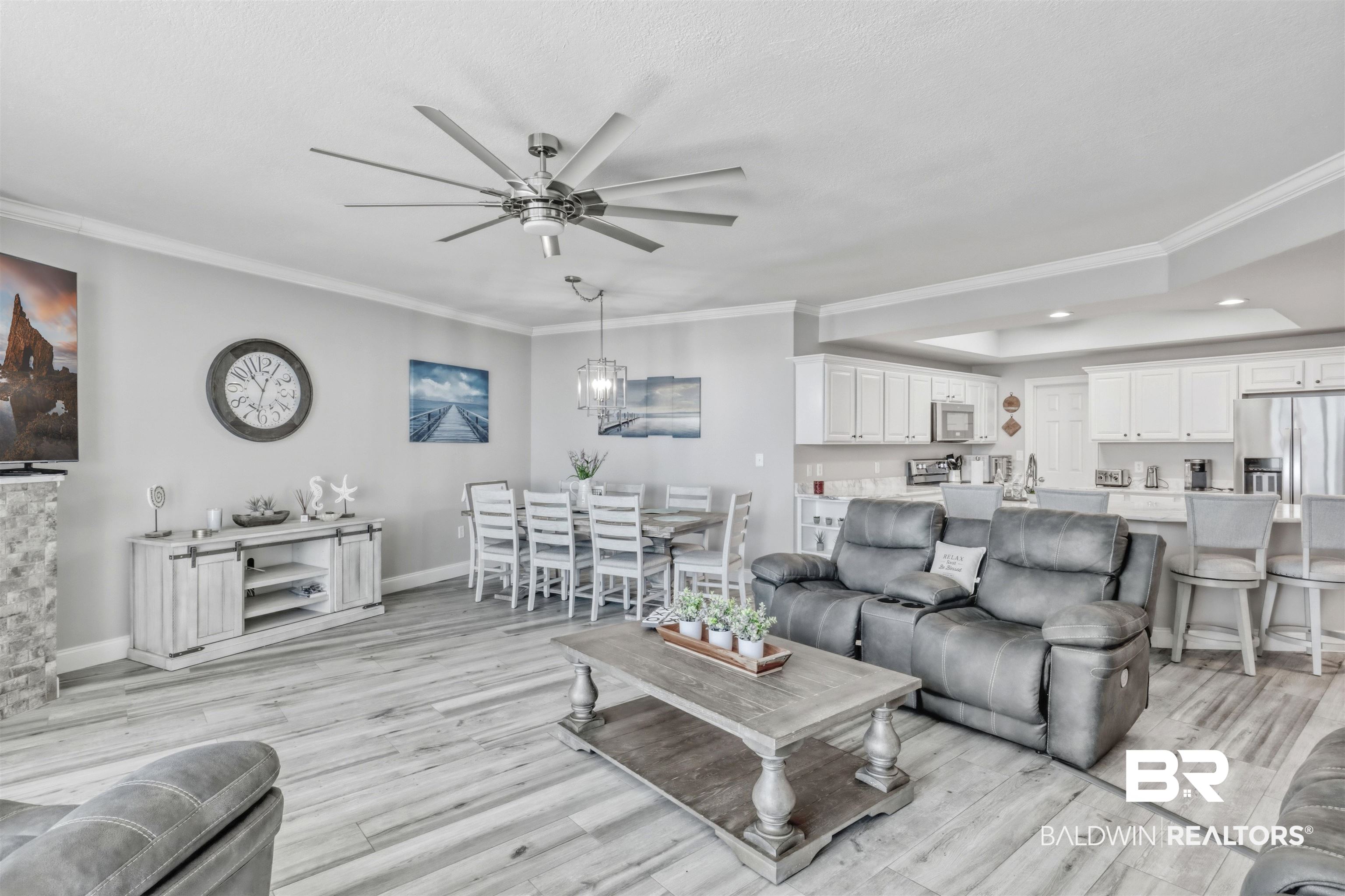 Living room with crown molding, a ceiling fan, light wood-style flooring, and recessed lighting