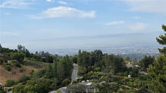 an aerial view of house with yard and mountain view in back