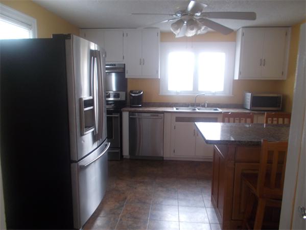 170 Lucerne Road Springfield, MA 01119 - Photo 10 of 28 a kitchen with stainless steel appliances granite countertop a refrigerator a sink a stove and island