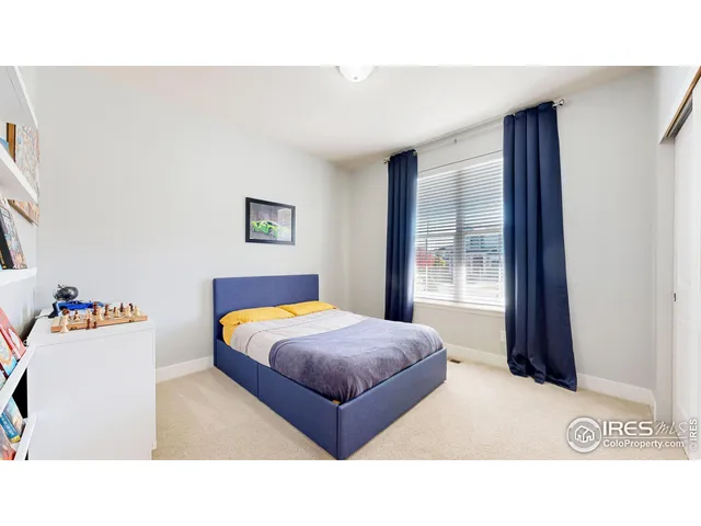 a bedroom with a bed and a large mirror