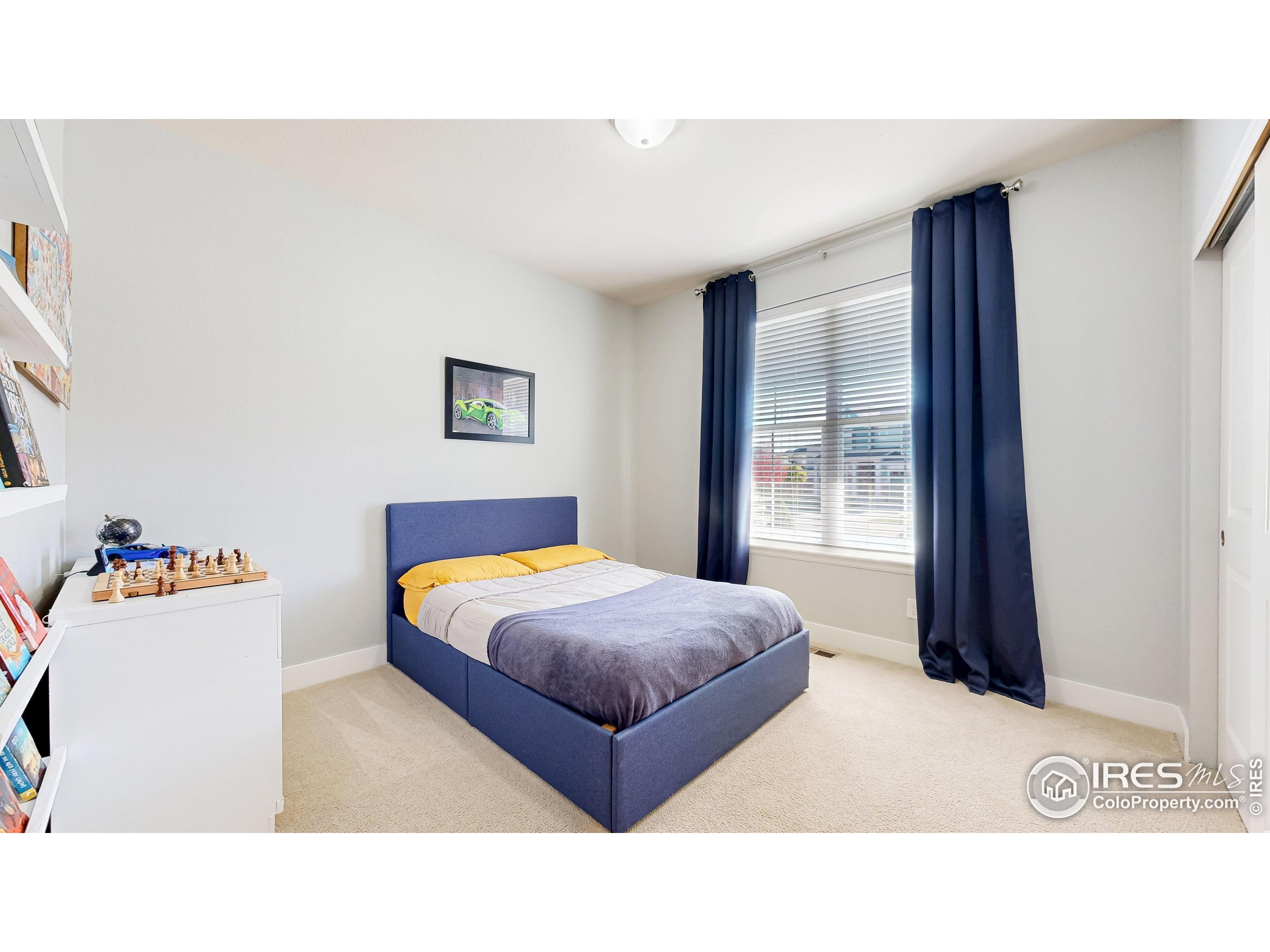 6794 Spring Rain Road Timnath, CO 80547 - Photo 17 of 49 a bedroom with a bed and a large mirror