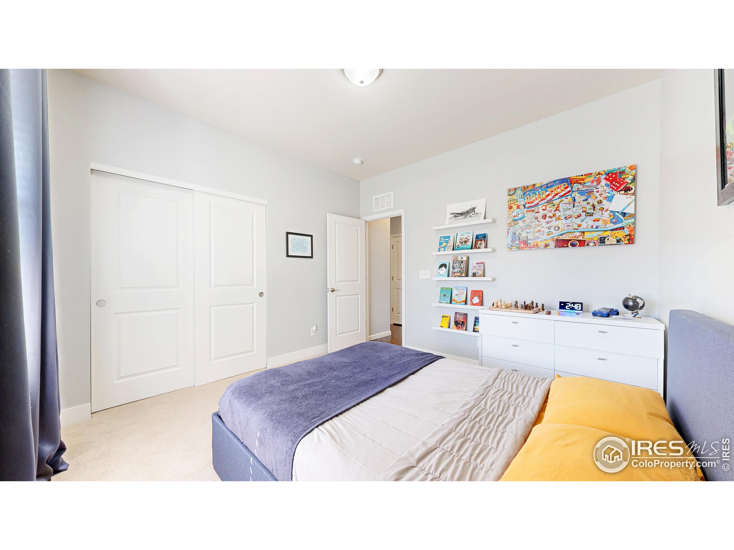 6794 Spring Rain Road Timnath, CO 80547 - Photo 18 of 49 a bedroom with a bed and a couch