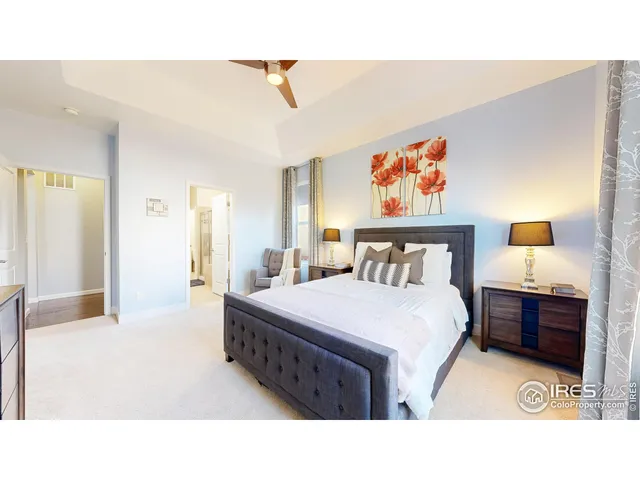 a bedroom with a bed and a painting on the wall