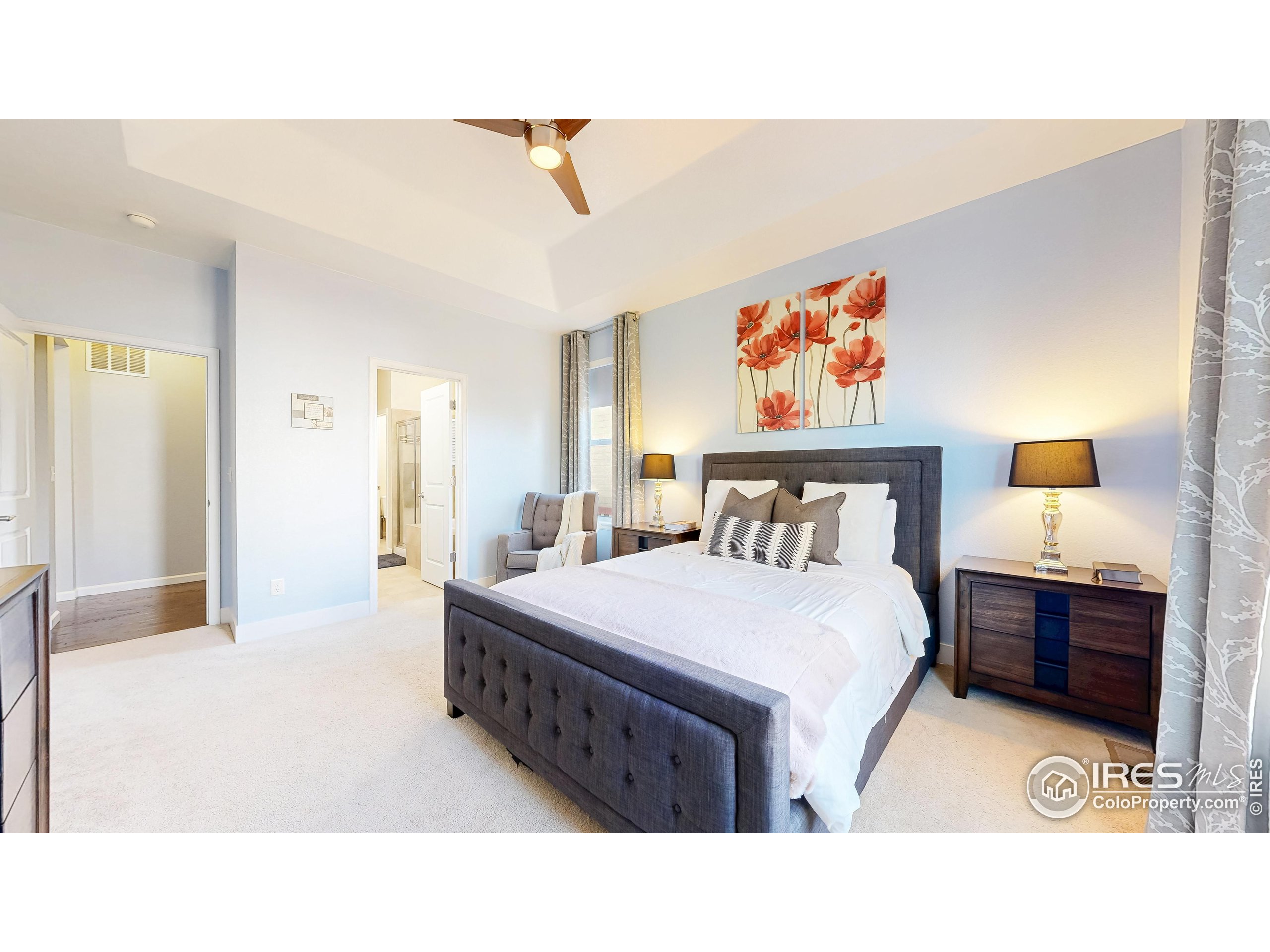 6794 Spring Rain Road Timnath, CO 80547 - Photo 21 of 49 a bedroom with a bed and a painting on the wall