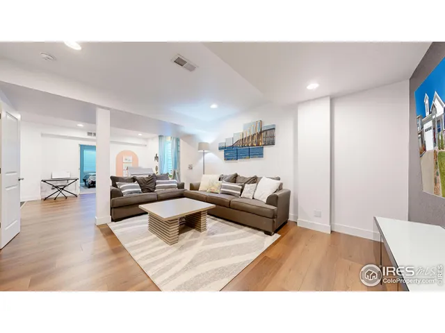 a living room with furniture and a dining table