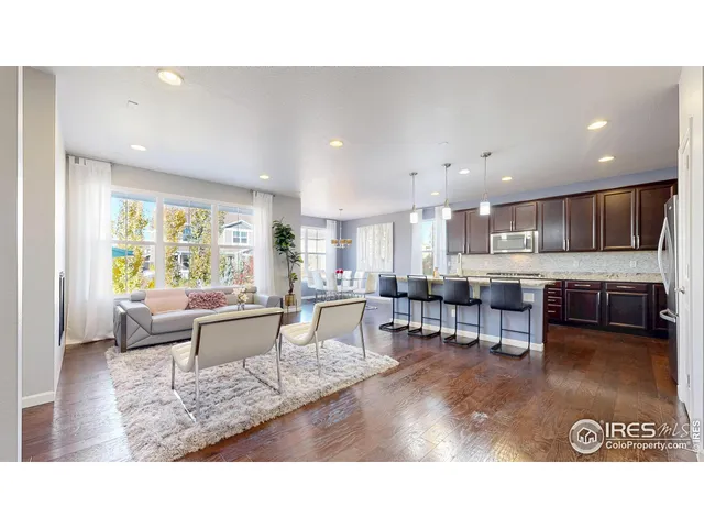 a living room with stainless steel appliances kitchen island granite countertop a living room and couches with kitchen view