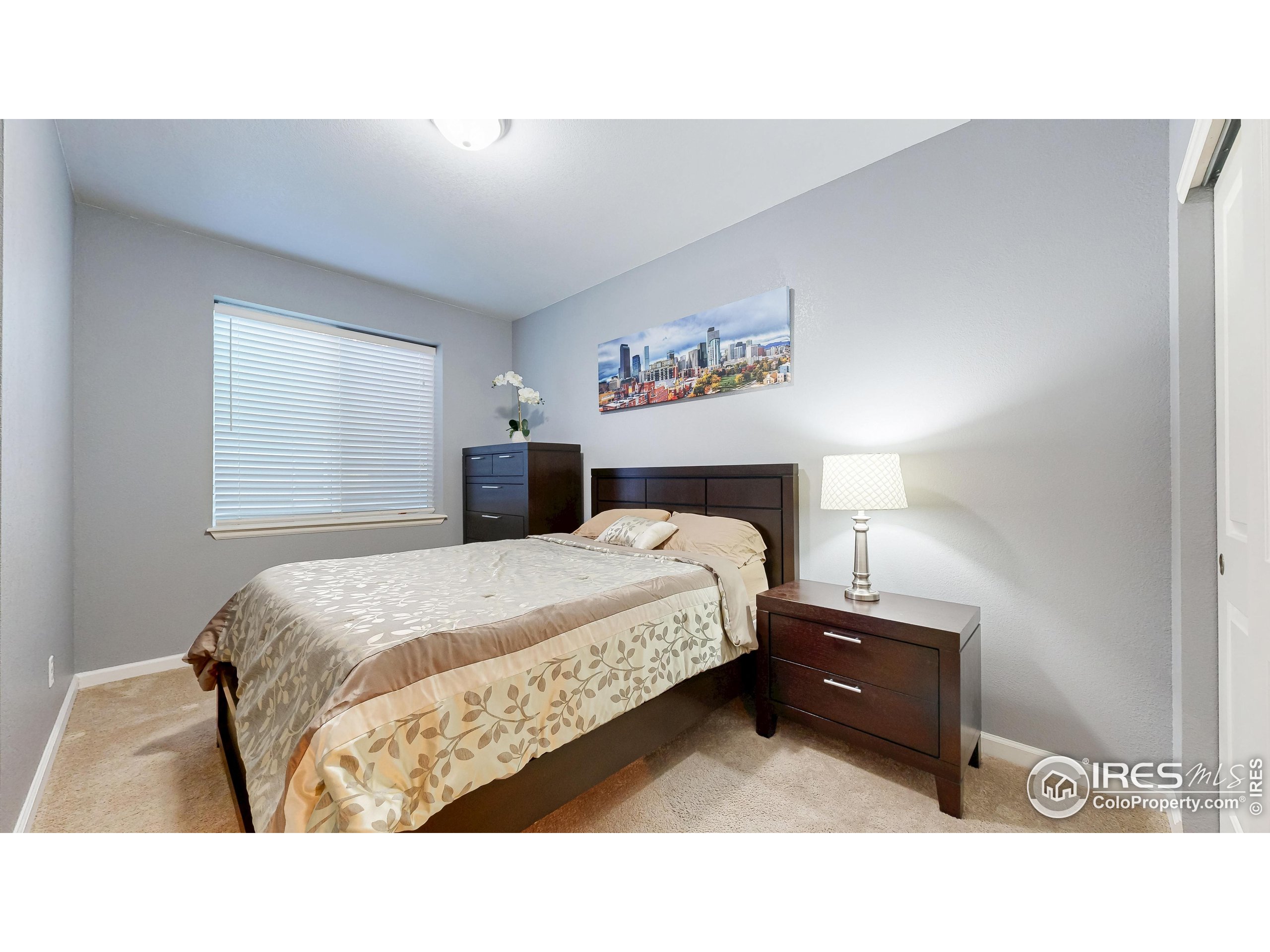 6794 Spring Rain Road Timnath, CO 80547 - Photo 35 of 49 a bedroom with a bed and a night stand