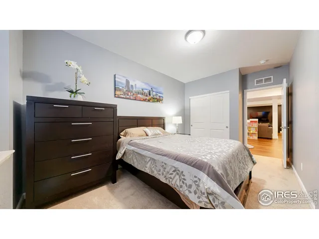 a bedroom with a bed and a mirror