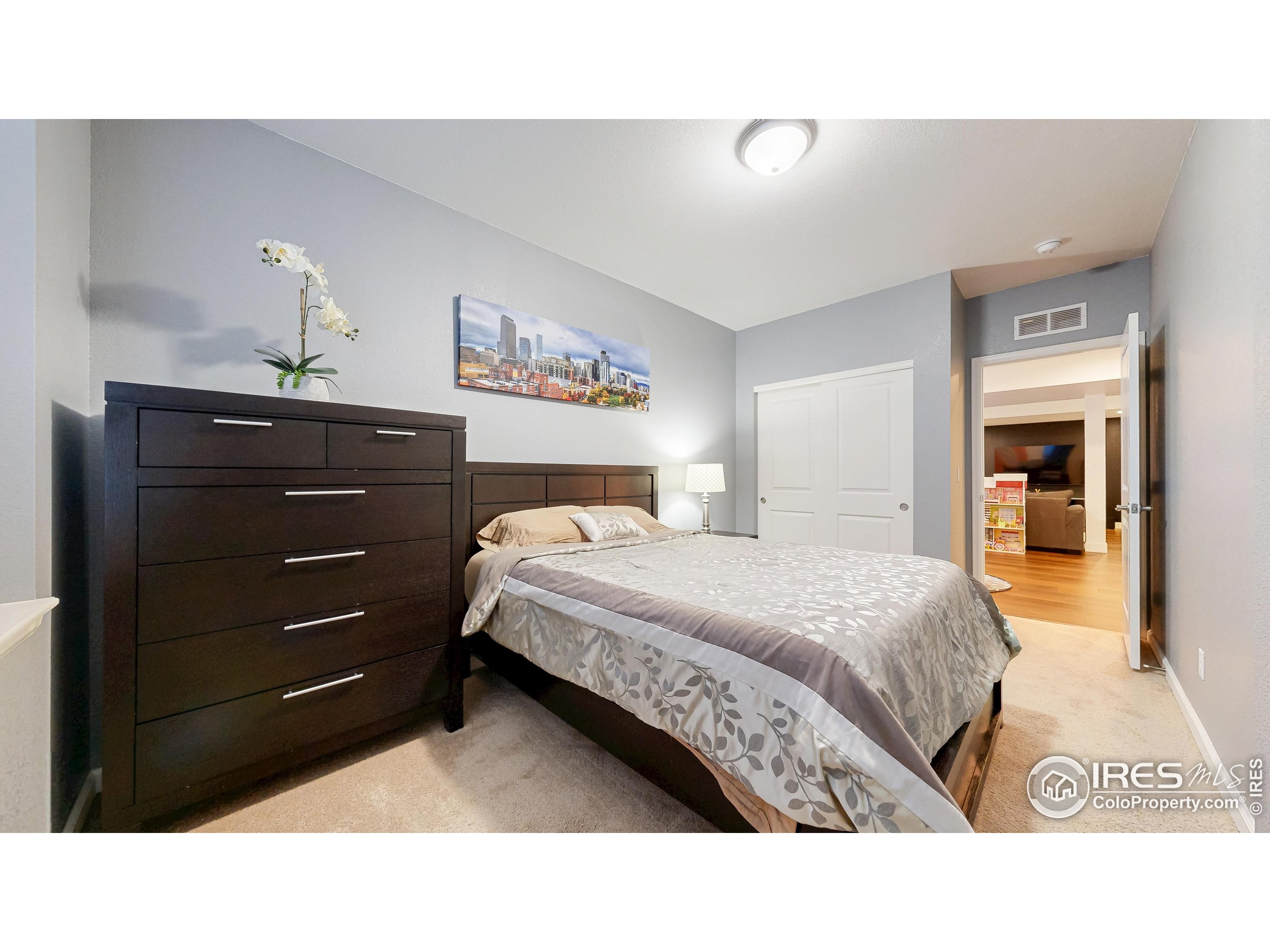 6794 Spring Rain Road Timnath, CO 80547 - Photo 36 of 49 a bedroom with a bed and a mirror