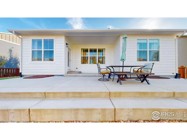 a swimming pool with outdoor seating and a lots of sitting space