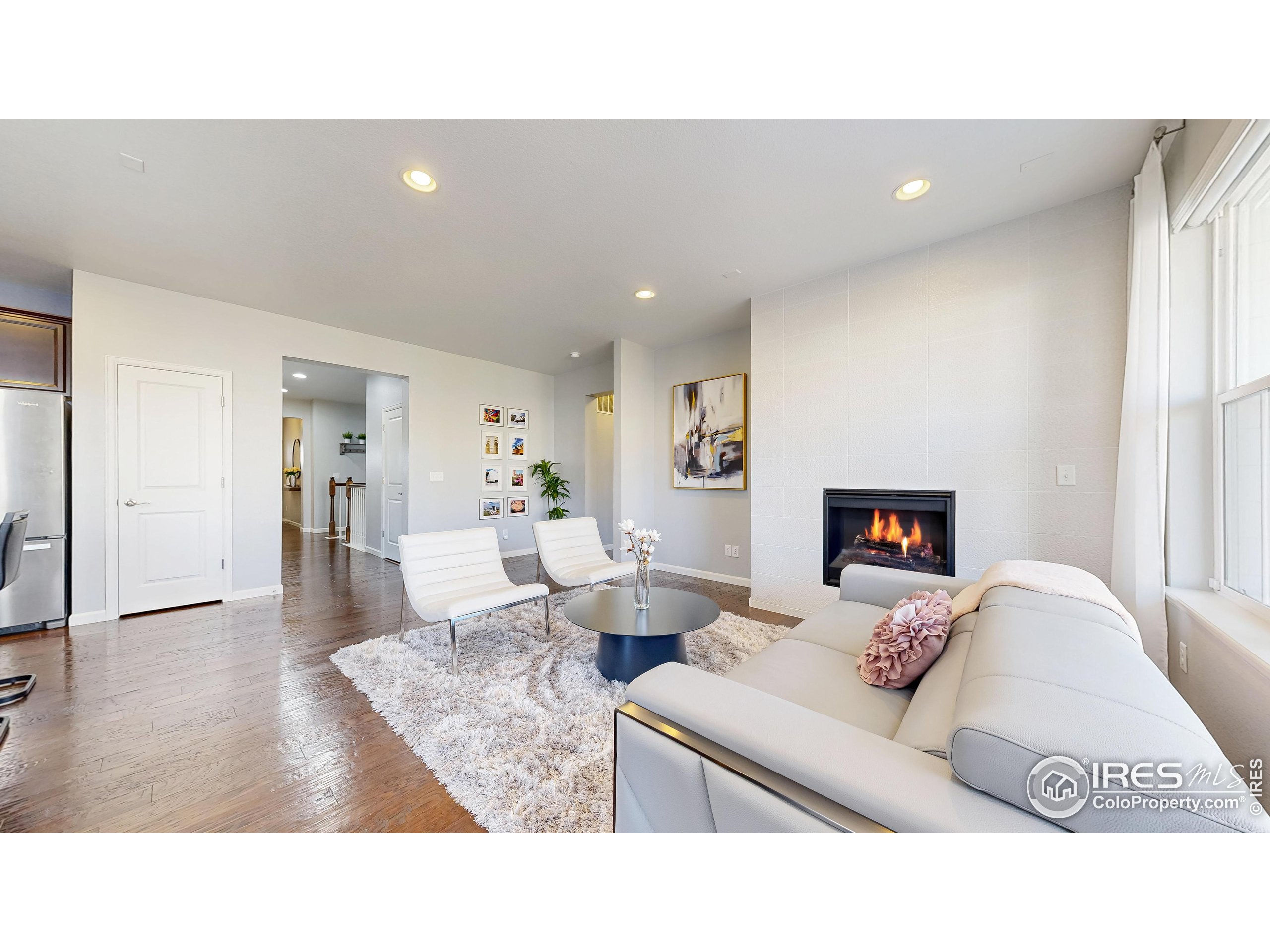 6794 Spring Rain Road Timnath, CO 80547 - Photo 5 of 49 a living room with furniture and a fireplace