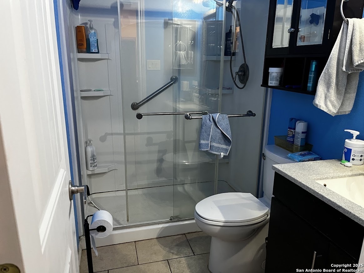 6613 Pebble Spring Drive San Antonio, TX 78249 - Photo 11 of 11 a bathroom with a toilet and a shower