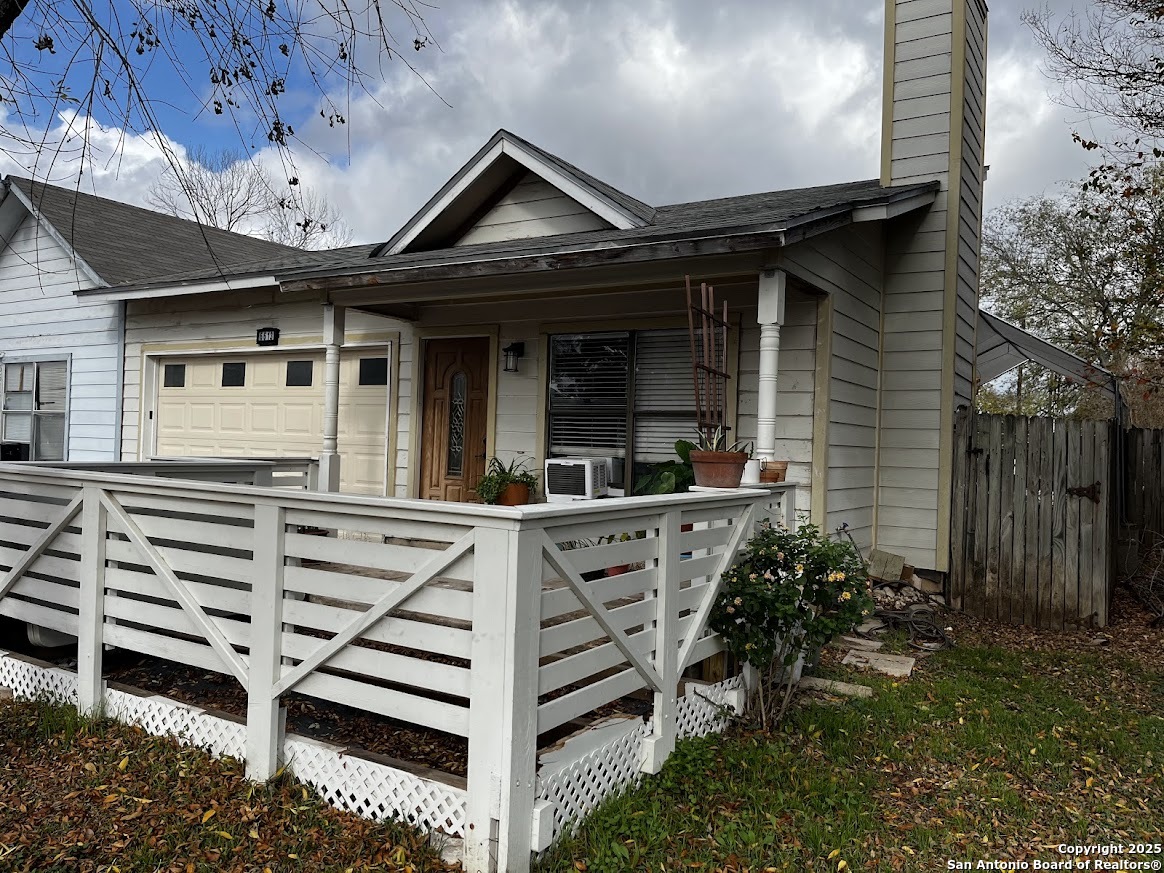 6613 Pebble Spring Drive San Antonio, TX 78249 - Photo 2 of 11 a view of a house with a large window and wooden walls