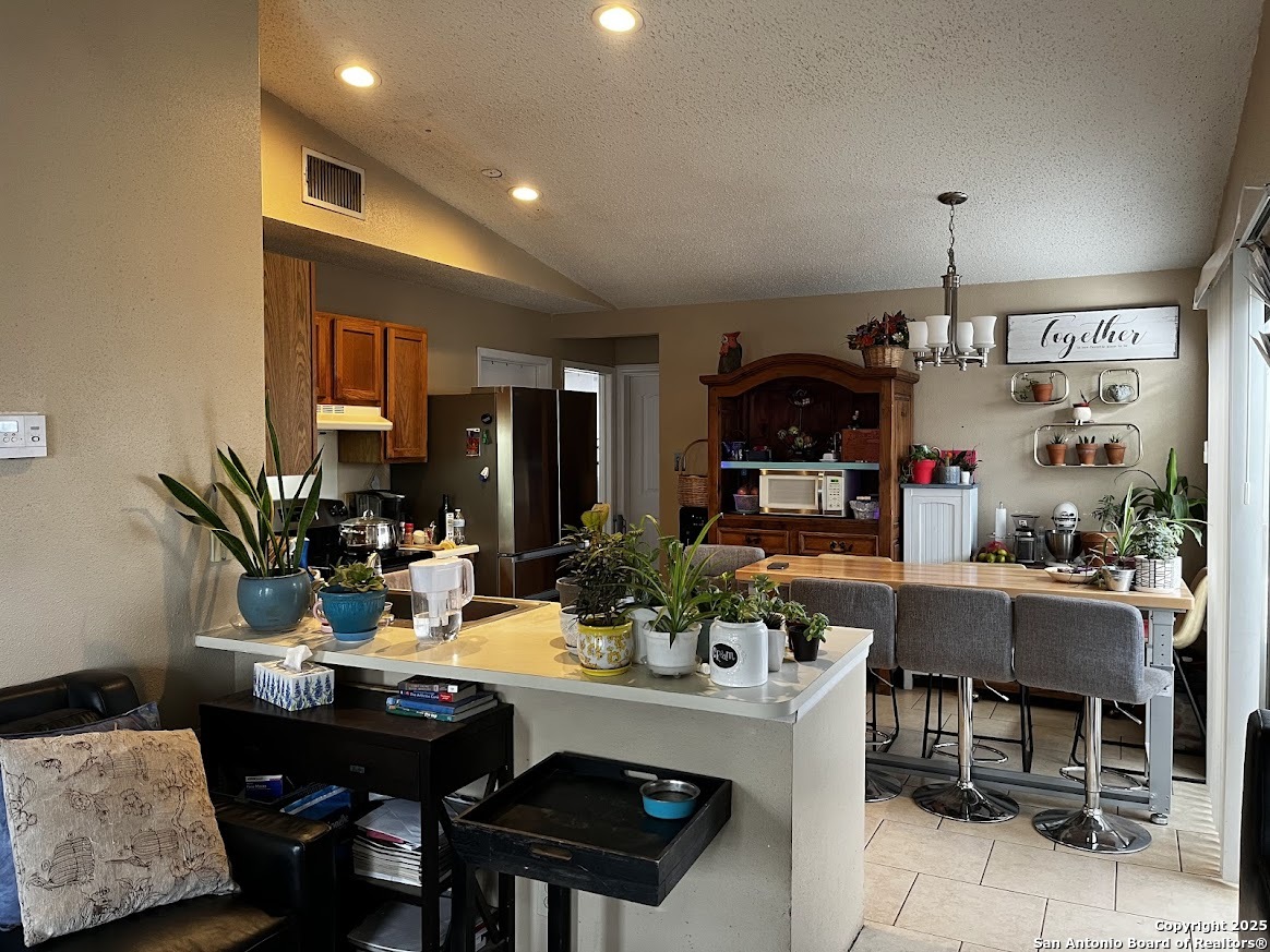 6613 Pebble Spring Drive San Antonio, TX 78249 - Photo 7 of 11 a view of a dining room with furniture window and outside view