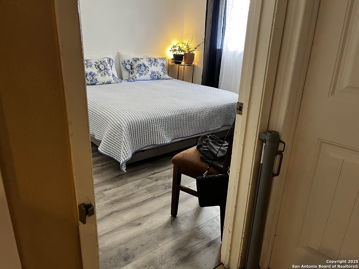 6613 Pebble Spring Drive San Antonio, TX 78249 - Photo 10 of 11 a bedroom with a bed and a mirror