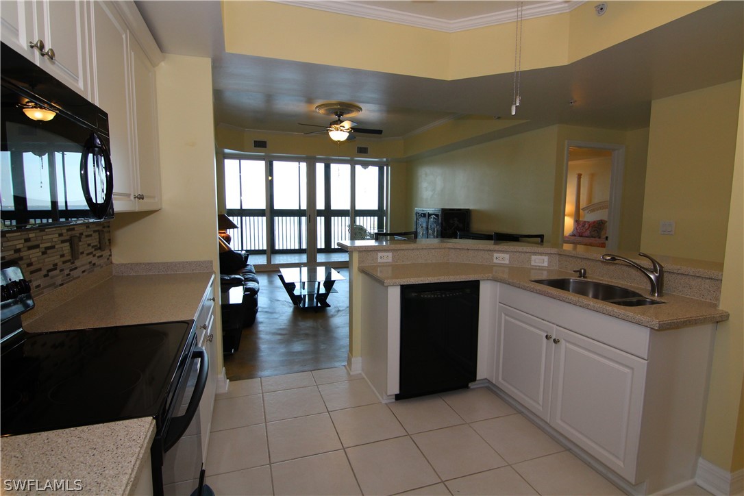 2797 First Street, Unit 804 Fort Myers, FL 33916 - Photo 12 of 34 a kitchen with a stove a sink and a refrigerator