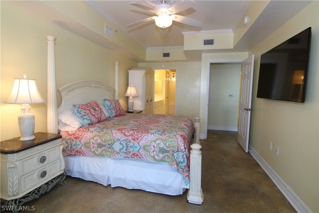 2797 First Street, Unit 804 Fort Myers, FL 33916 - Photo 18 of 34 a spacious bedroom with a bed and a flat screen tv