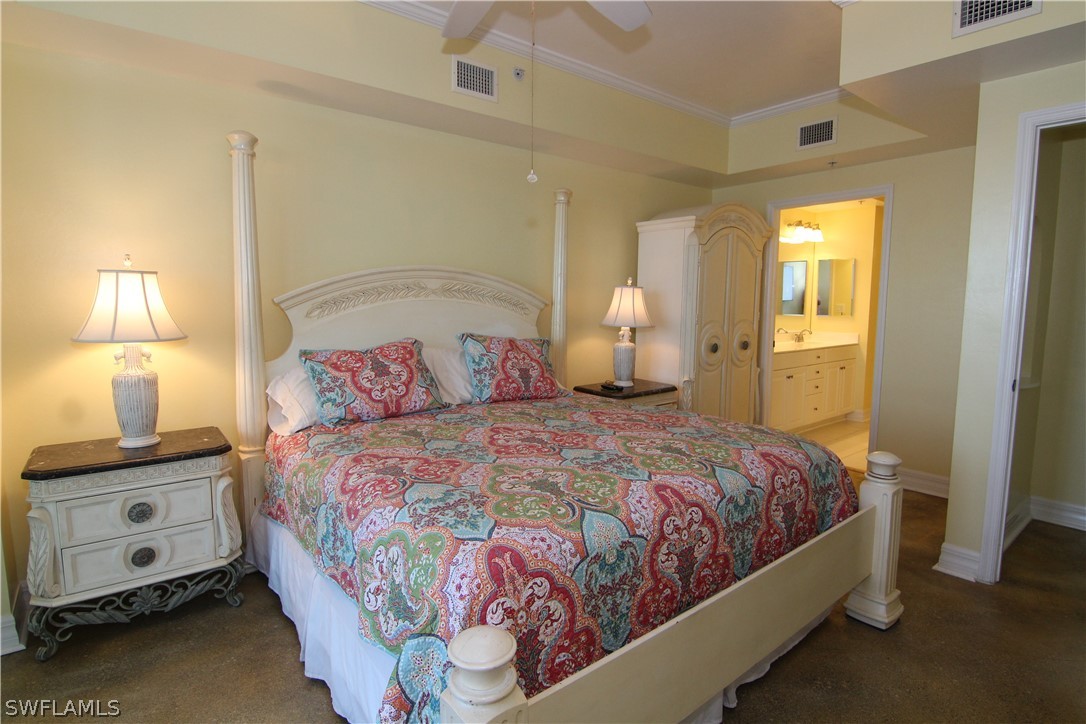 2797 First Street, Unit 804 Fort Myers, FL 33916 - Photo 19 of 34 a bedroom with a bed and a night stand