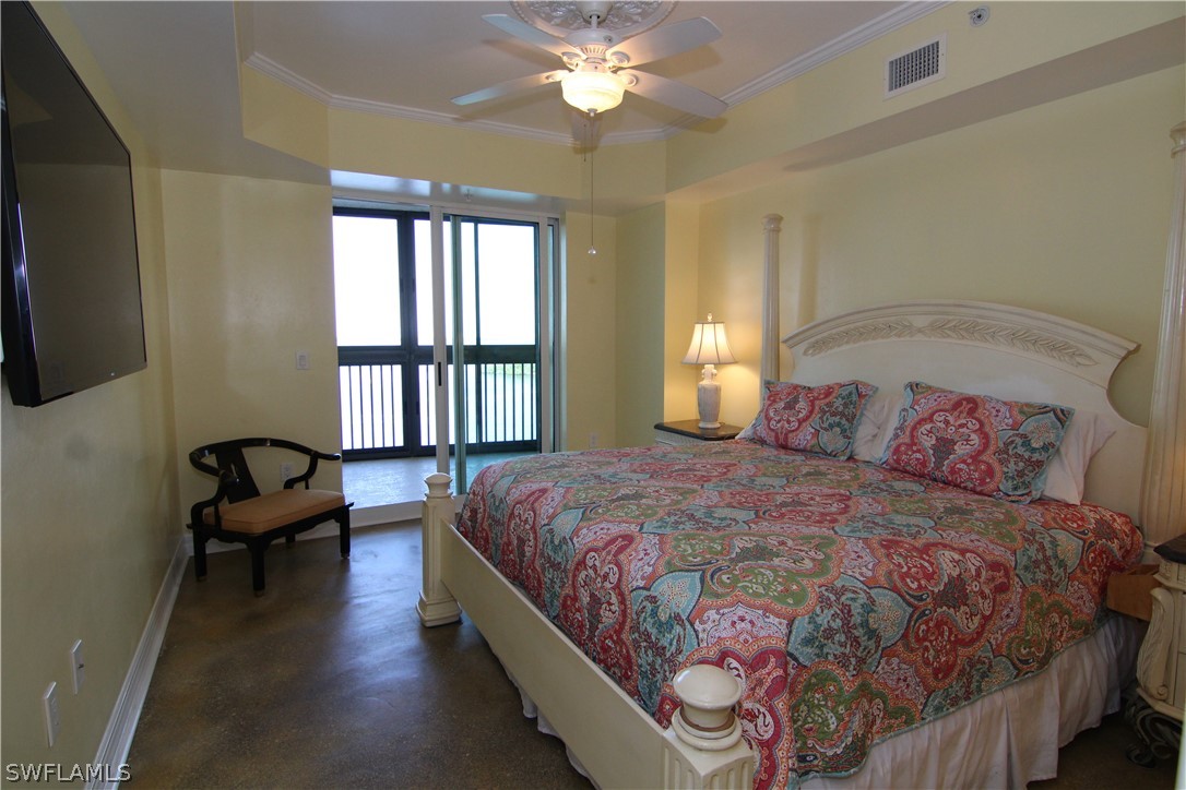 2797 First Street, Unit 804 Fort Myers, FL 33916 - Photo 20 of 34 a bedroom with a bed and a chandelier