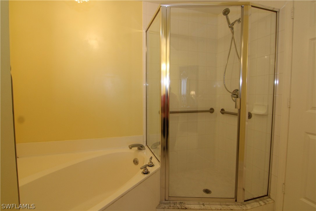 2797 First Street, Unit 804 Fort Myers, FL 33916 - Photo 23 of 34 a bathroom with a bathtub and a shower