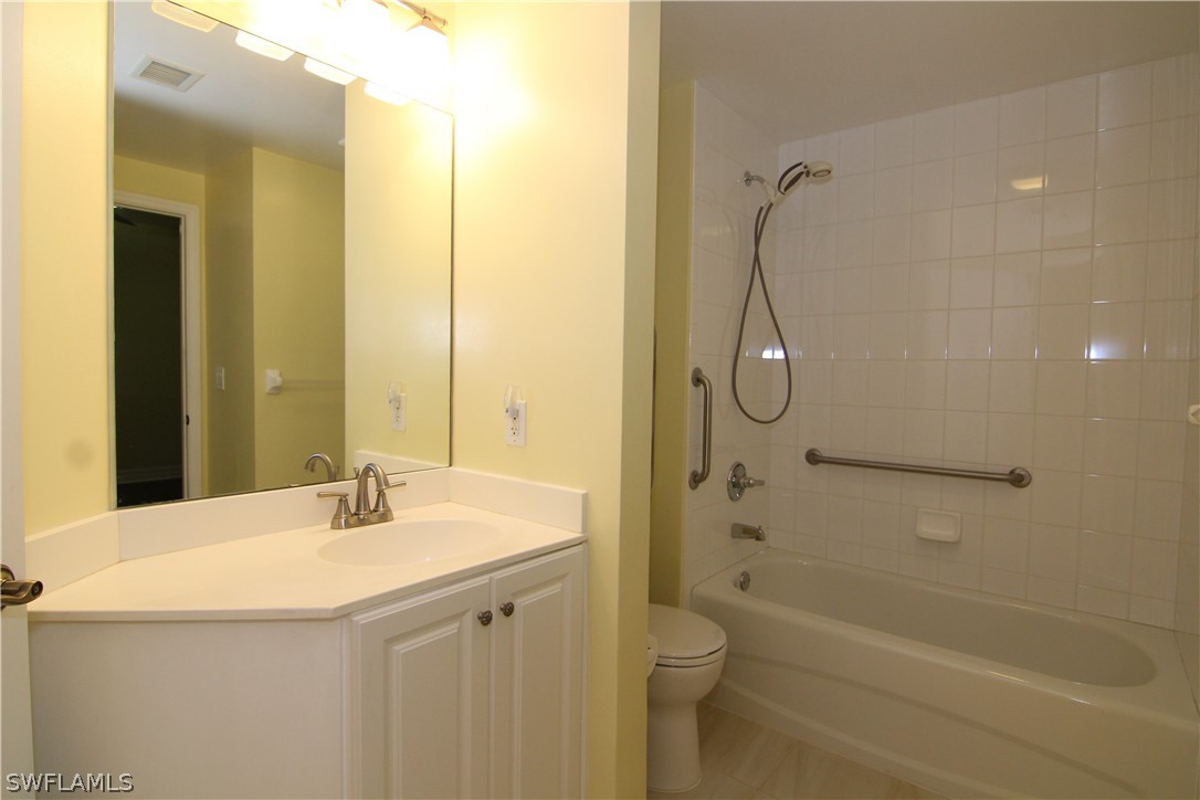 2797 First Street, Unit 804 Fort Myers, FL 33916 - Photo 28 of 34 a bathroom with a granite countertop sink a toilet and shower